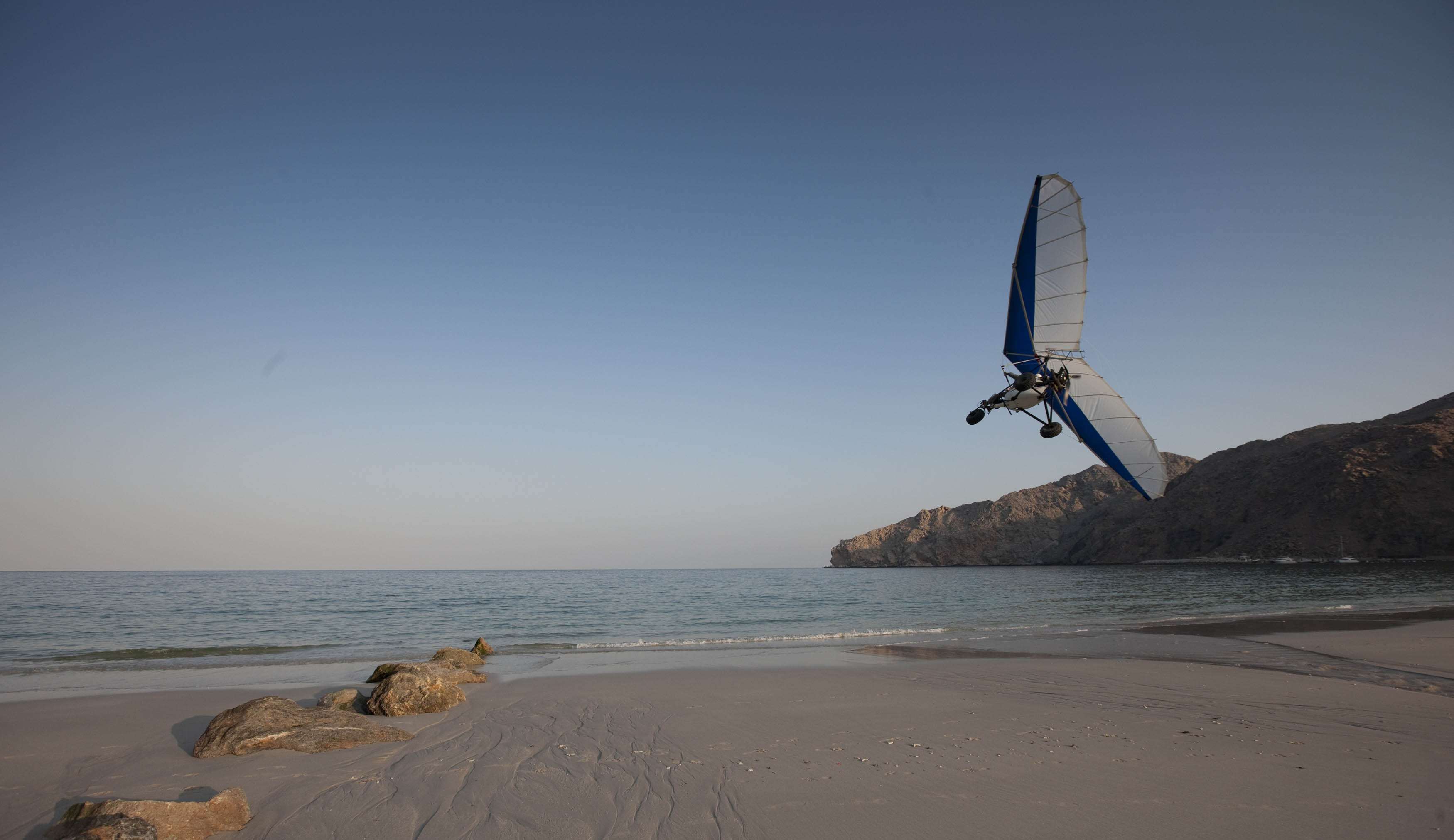 Winter sun wellness in Oman paragliding at Zighy Bay