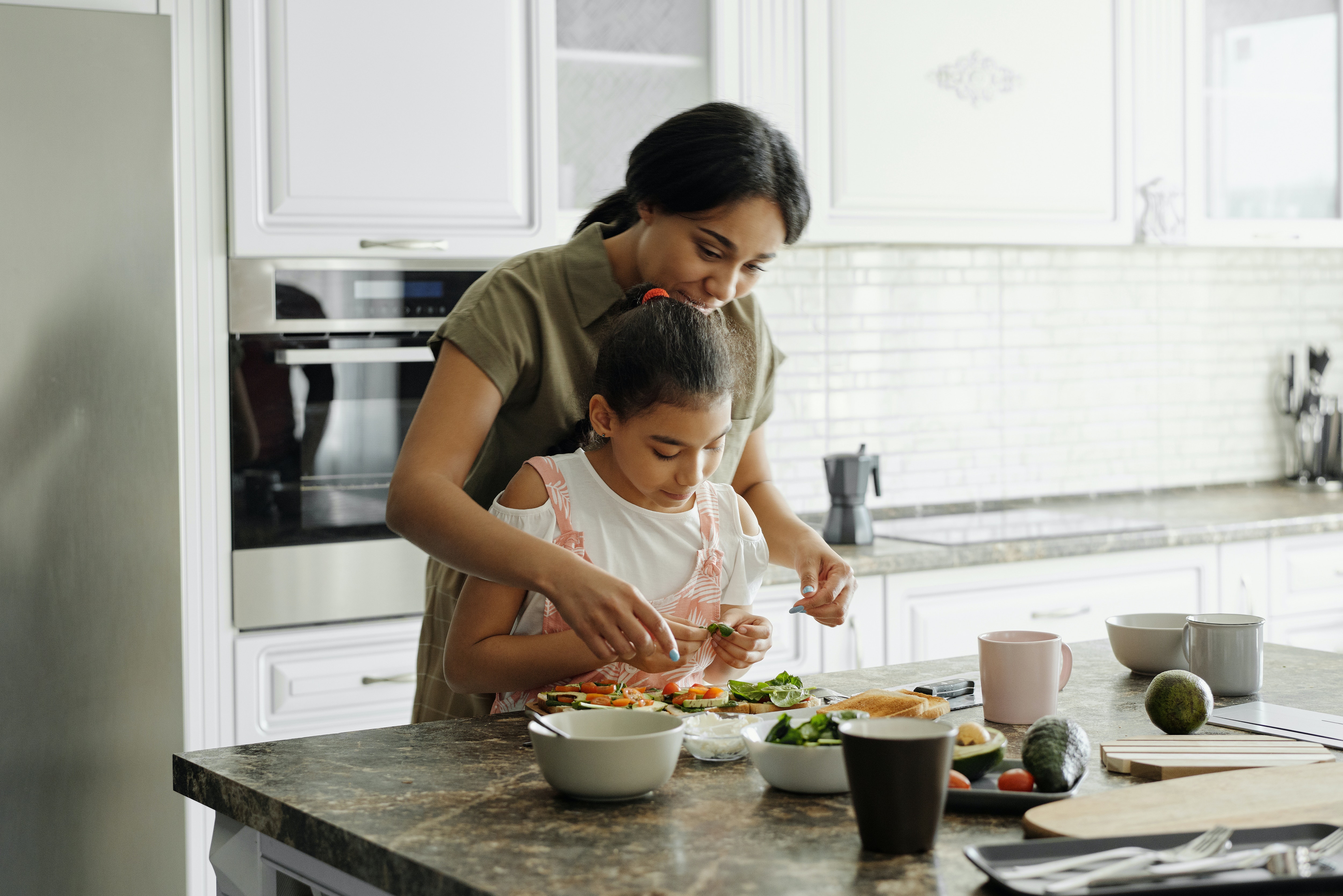 Mother and daughter preparing healthy food