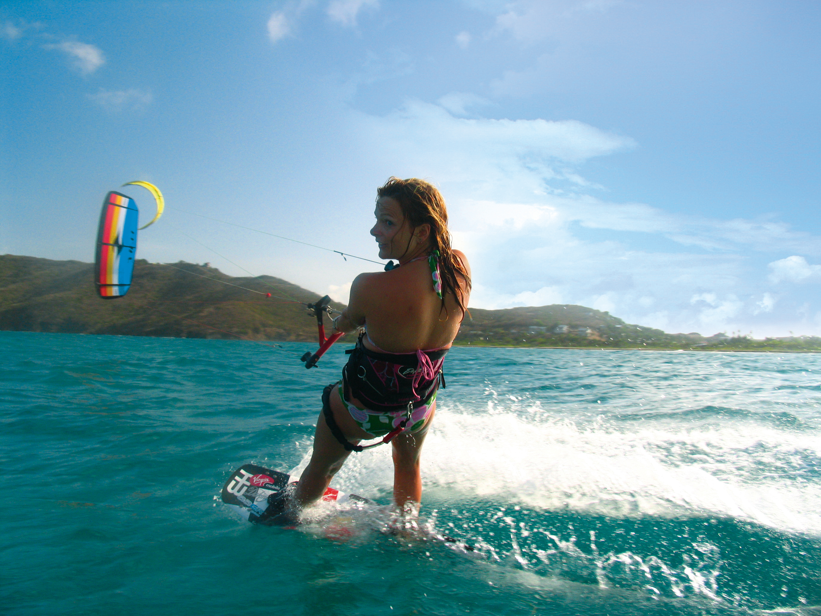 Woman kitesurfing in the ocean